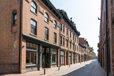 Row of Historic Brick Townhouses on Cobblestone Street