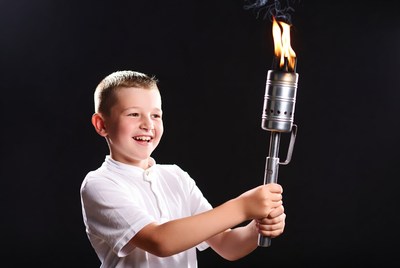 Boy holding lit Olympic torch