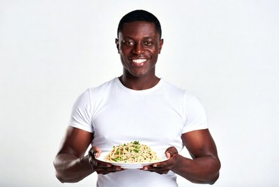 African-American man holding spaghetti plate