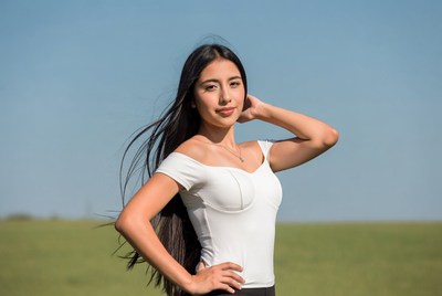 Asian woman posing in green field
