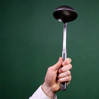 Man's hand holding ladle
