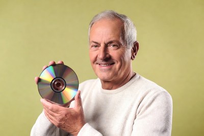 Senior man holding CD disc
