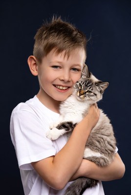 Boy holding fluffy kitten