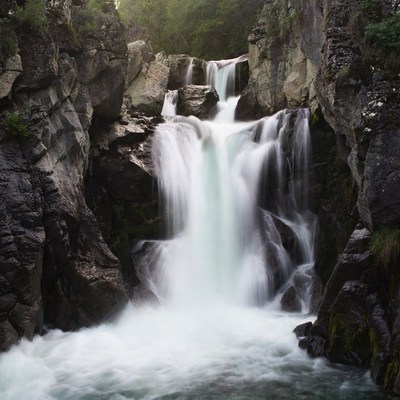 Waterfall cascading between rocky cliffs
