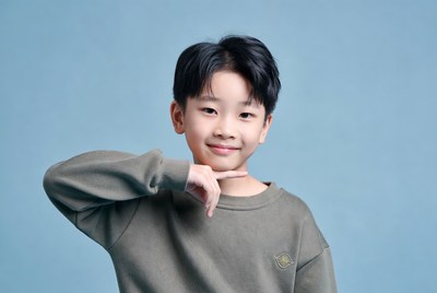 Asian boy making finger gun gesture