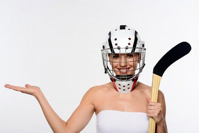 Woman in hockey goalie mask with stick