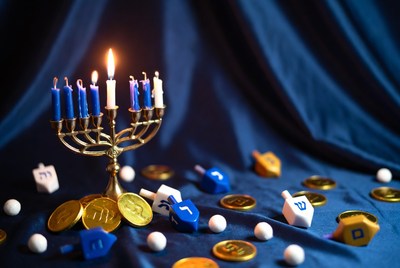 Lit Hanukkah Menorah with Dreidels and Coins