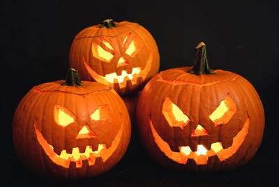 Three lit jack-o-lantern pumpkins