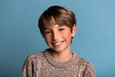 Smiling boy in brown sweater