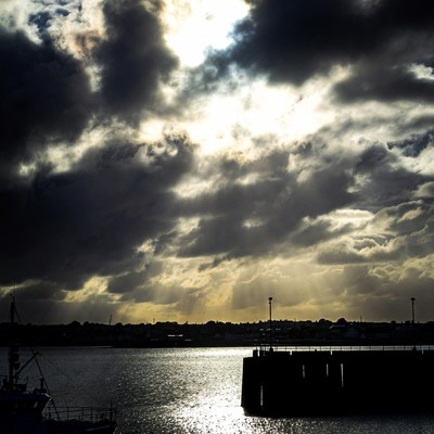 Dramatic Clouds Over Harbor Dock
