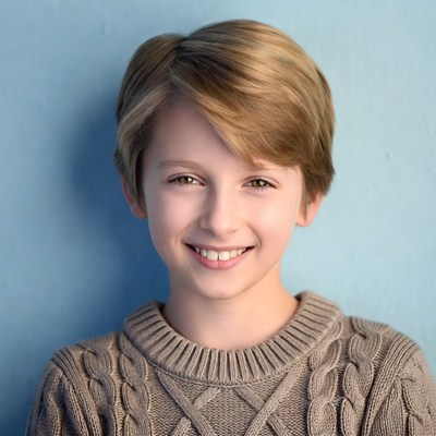 Smiling boy in cable knit sweater