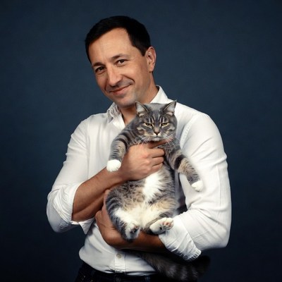 Man holding gray tabby cat