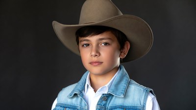 Boy wearing cowboy hat and vest
