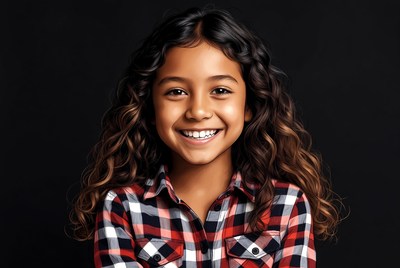 Smiling mixed-race girl in plaid shirt