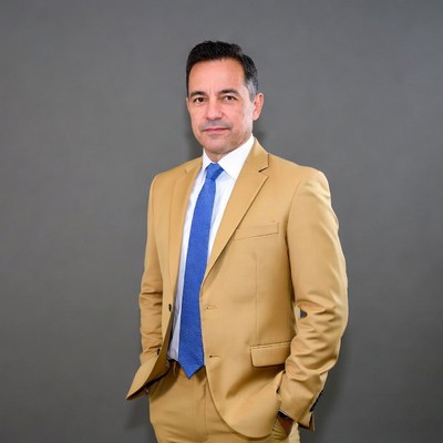 Man in tan suit with blue tie