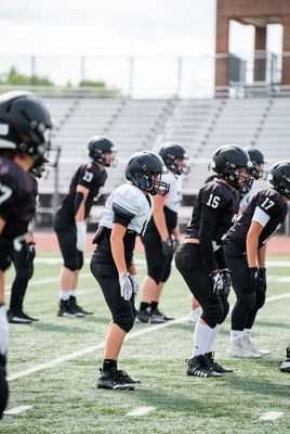 Football players huddled on field