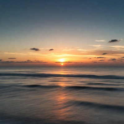 Sunset over calm ocean waves