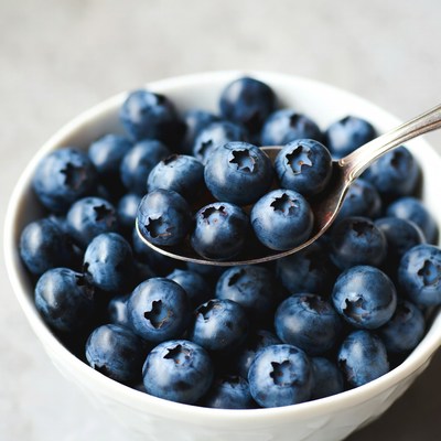 Blueberries in white bowl with spoon