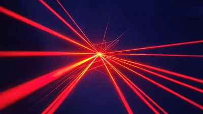 Red laser beams on dark background