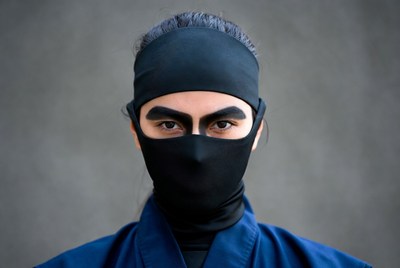 Asian woman in ninja mask and outfit