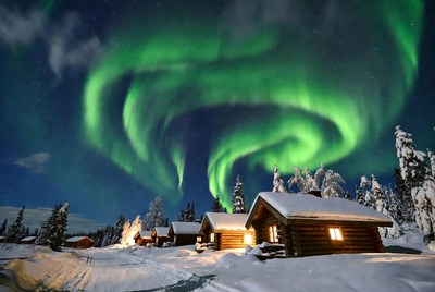 Aurora Borealis over Snowy Log Cabins