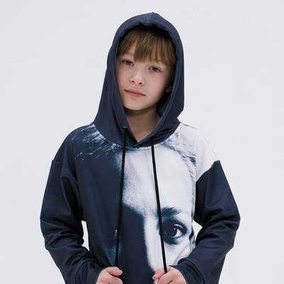 Boy wearing oversized hoodie with face print