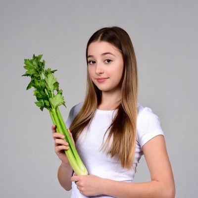 Girl holding celery stalks