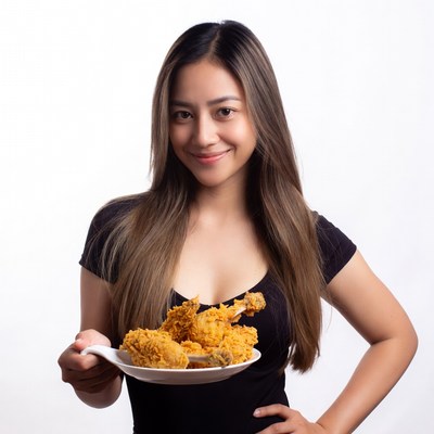 Asian woman holding fried chicken