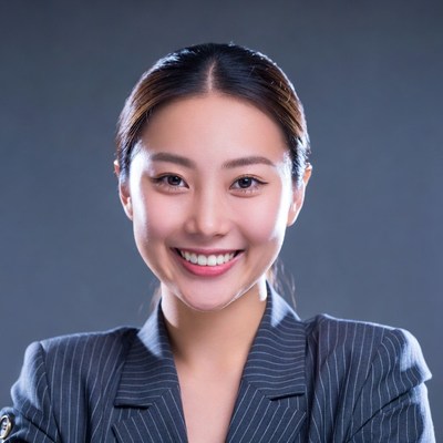Asian woman smiling in gray suit