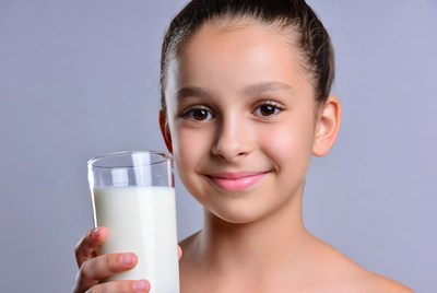 Girl holding glass of milk