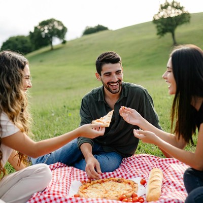Friends Eating Pizza Picnic Outdoors