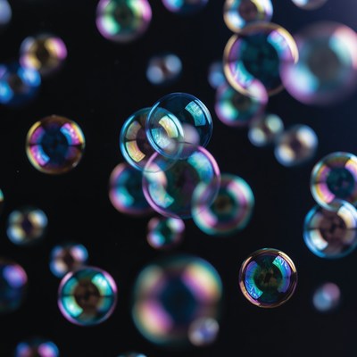 Colorful soap bubbles floating on black