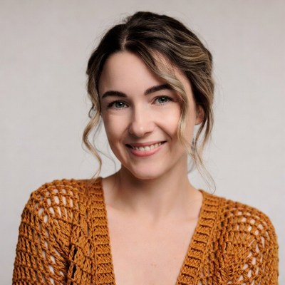 Smiling woman in orange knit sweater