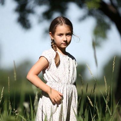 Girl in white dress in grass field