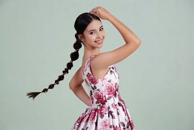 Asian girl with braided hair in floral dress