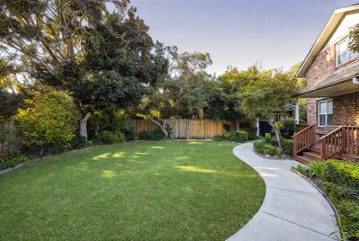 Backyard with Curved Path and Wooden Deck