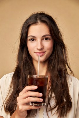Woman drinking iced coffee with straw