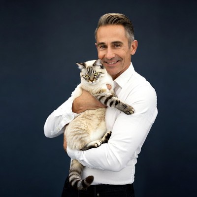 Man holding white cat