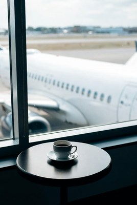 Coffee cup by airport window