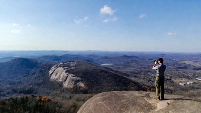 Man photographing mountain vista