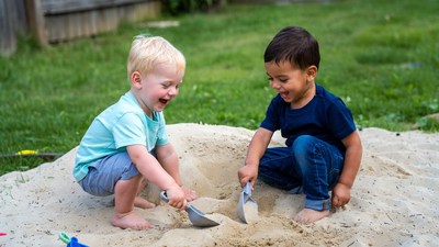 Two boys playing with sand