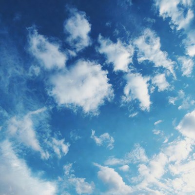 Fluffy white clouds in blue sky