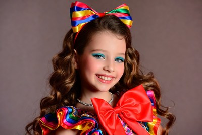 Girl with colorful bow headband smiling