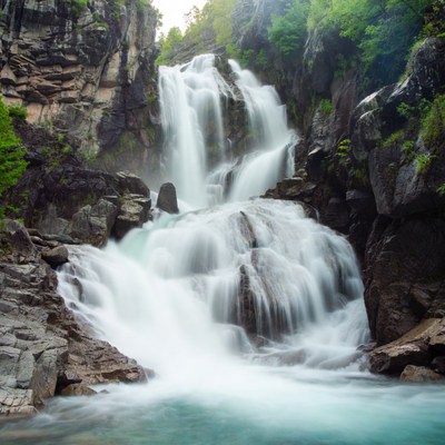 Majestic waterfall cascading rocks green forest