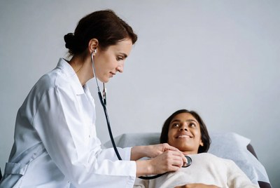Doctor checking patient's heartbeat