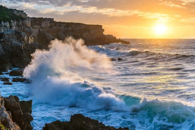 Ocean Waves Crashing on Cliff at Sunset