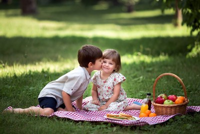 Boy kissing girl on picnic