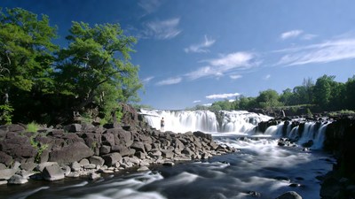 Person at cascading waterfall rocks