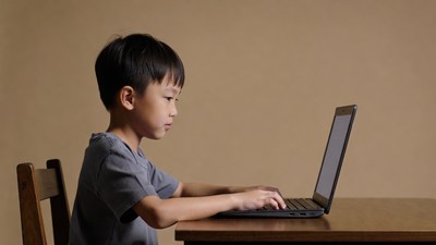 Asian boy using laptop