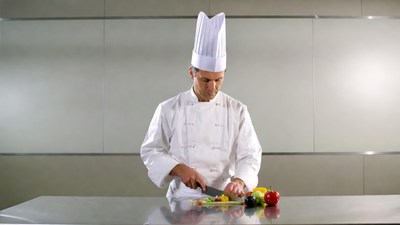Chef chopping vegetables on counter